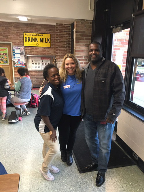 Interact 's Camille Tedeschi (center) with guard Sylvia Belanger and Young Leaders founder Kevin Thorbourne.