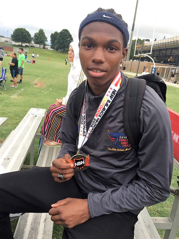 Kyree Johnson wears his national championship gold meda