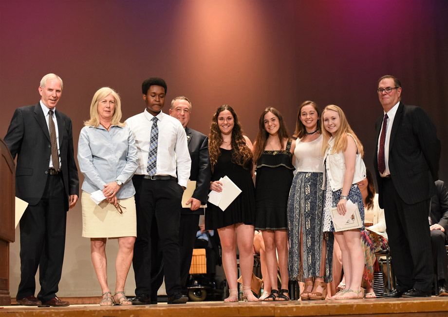 Rotary Club officials with the five Huntington High School scholarship recipients.