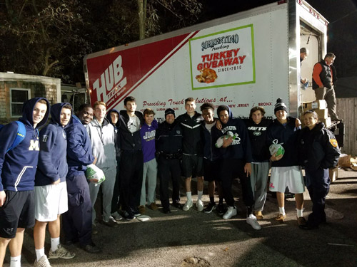 Huntington varsity boys' basketball players participated in a turkey giveaway.