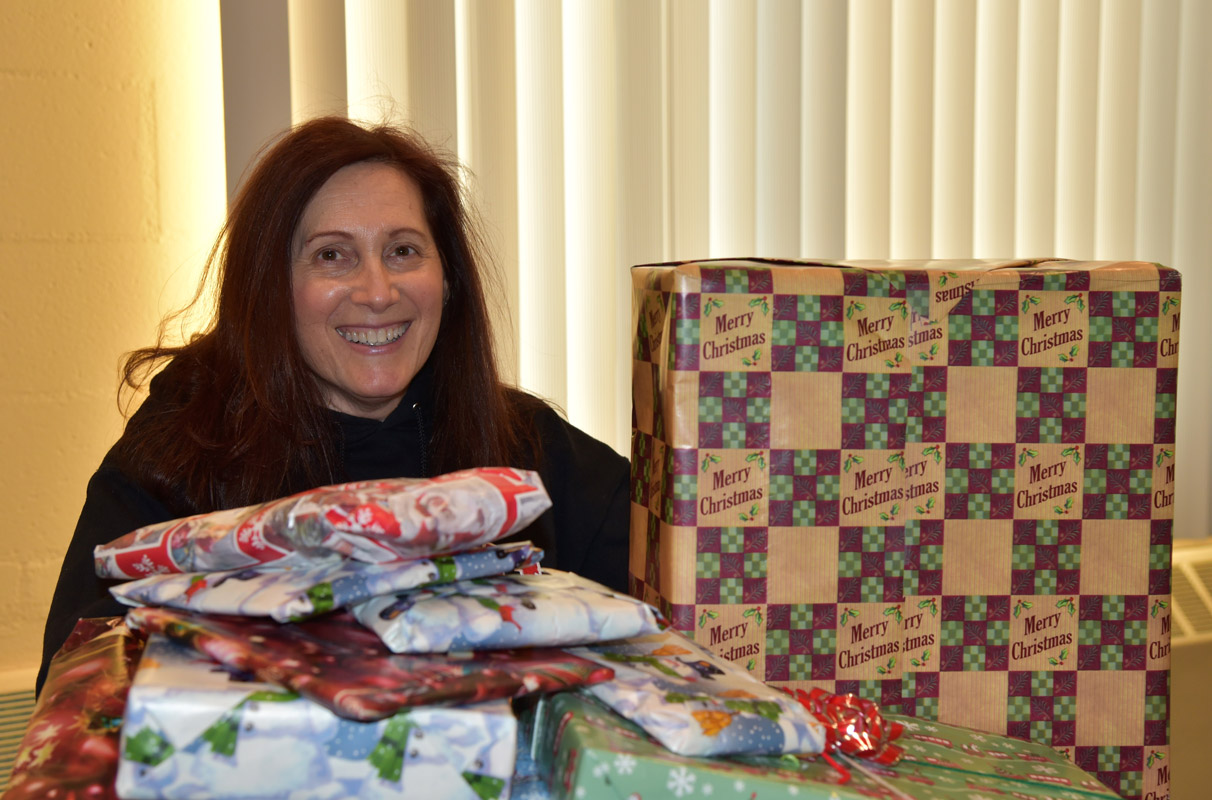 Huntington UFSD social worker Linda Kohan with some of the gifts for families. 