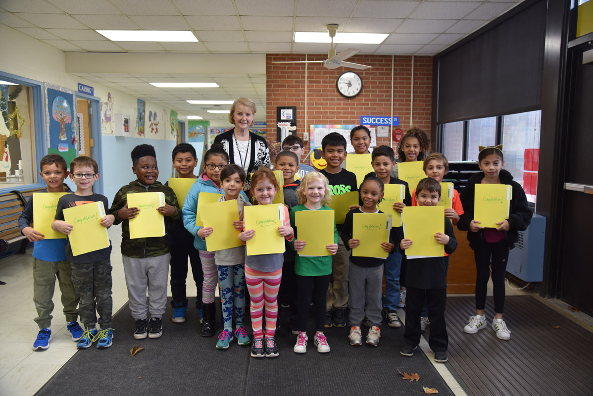 Principal Marsha Neville with Washington's Featured Artists for December.