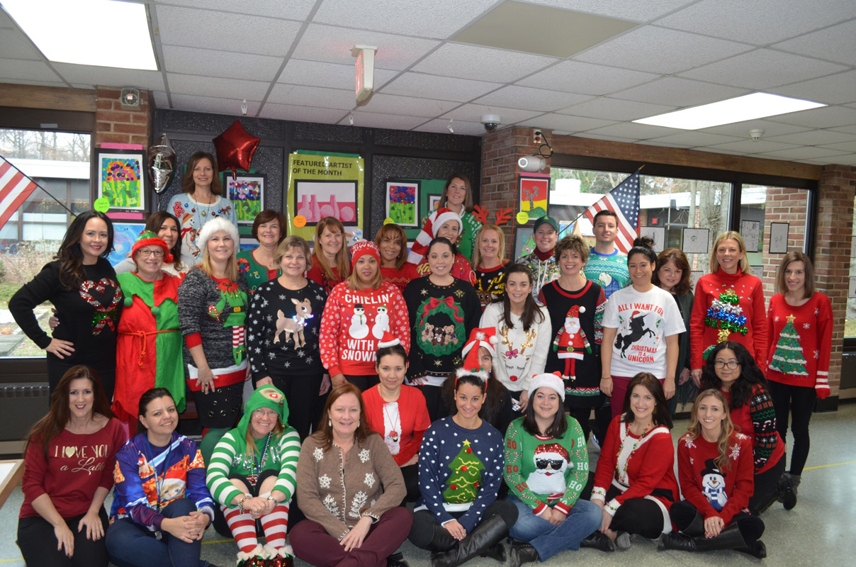 Jefferson School faculty and staff wearing their holiday sweaters.