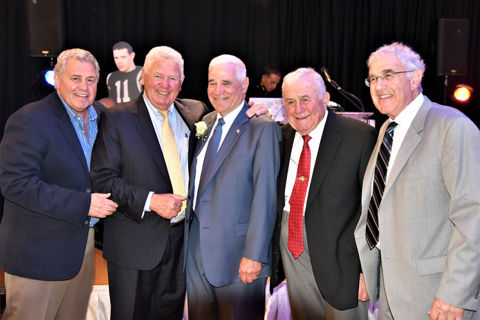 Booster Club honoree Jerry Asher is flanked by the Forte brothers.