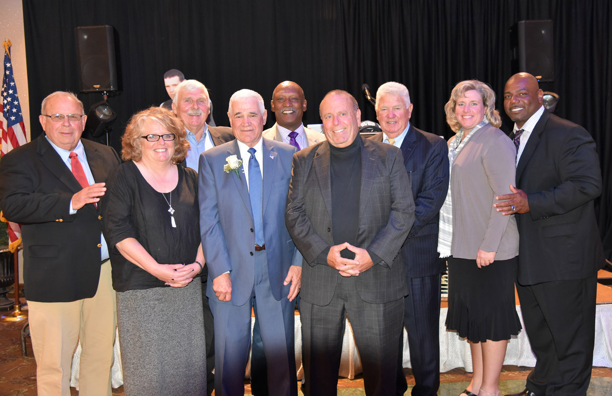 Jerry Asher (center with flower) is surrounded by past Booster Club honorees.