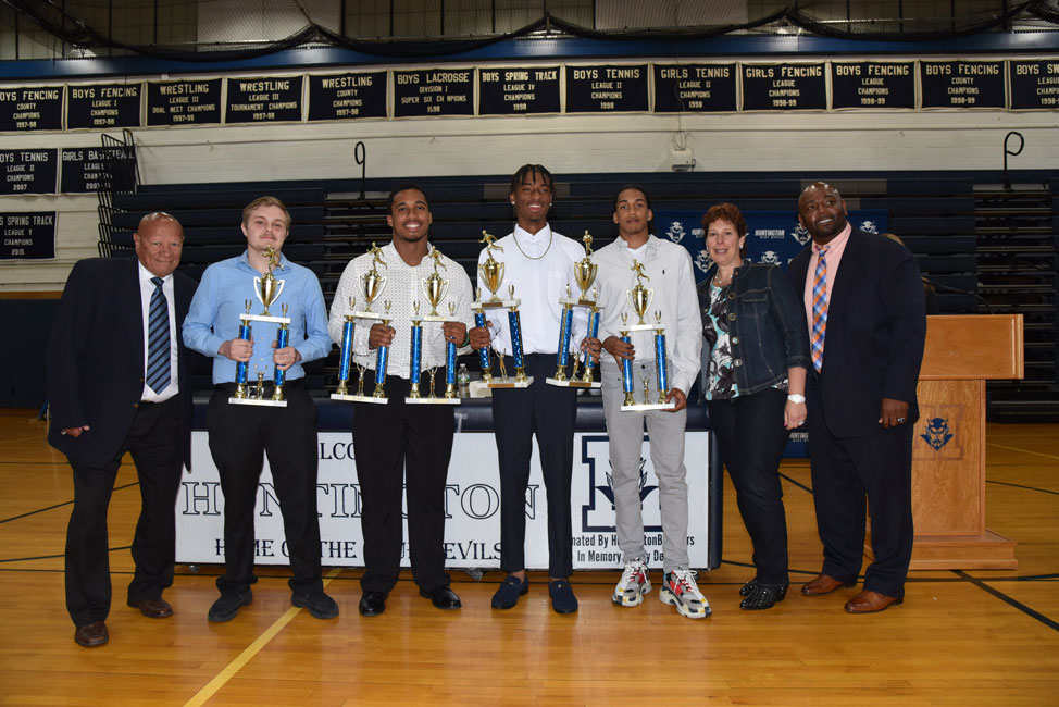 Blue Devil boys' track and field coaches Eli Acosta, Haidee Ganz-Bonhurst and Ron Wilson with senior award recipients.