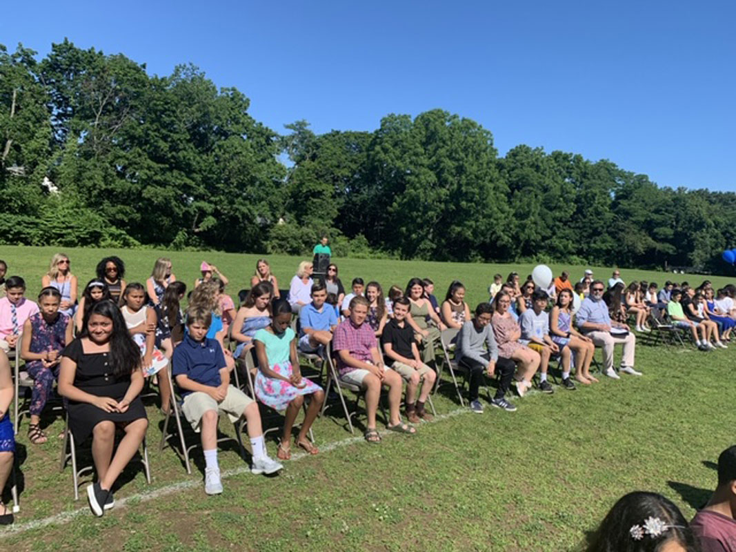 Woodhull School's sixth grade moving up ceremony was held outside on the lower athletic field.  