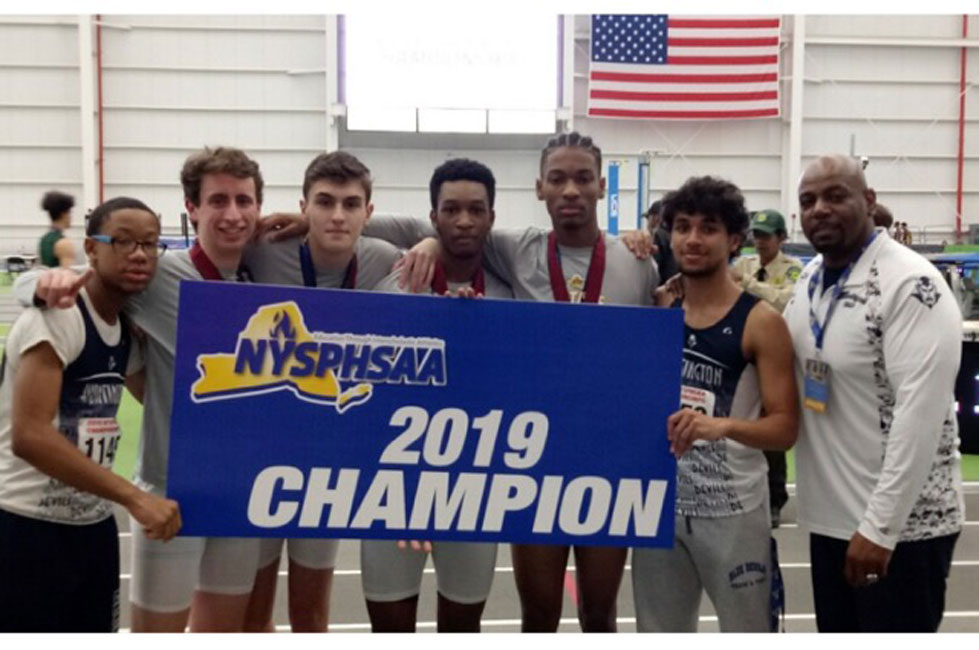 Huntington head coach Ron Wilson with the state championship 4x400m relay team on Saturday afternoon.