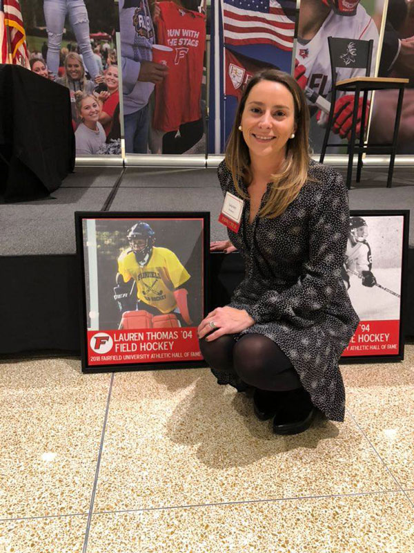 Lauren Thomas-Desiderio in front of a display recognizing her Hall of Fame induction.