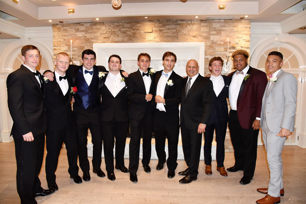 Blue Devil football coach Steve Muller was surrounded by his players at last year's prom.