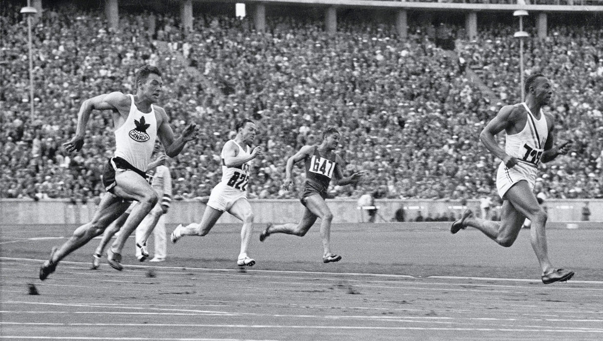 Jesse Owens (right) has the lead in the 1936 Olympics.