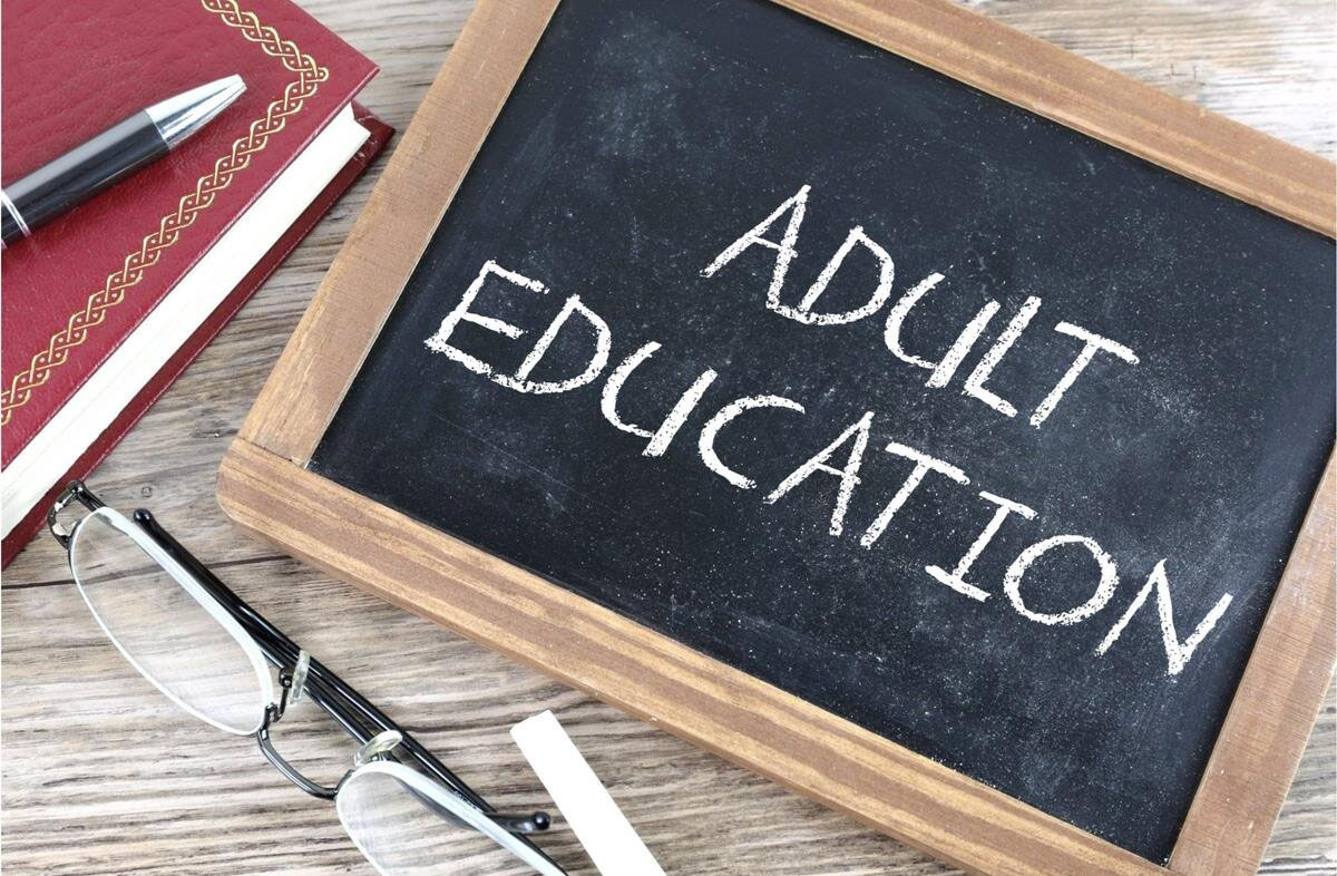 A small blackboard with Adult Education written on it