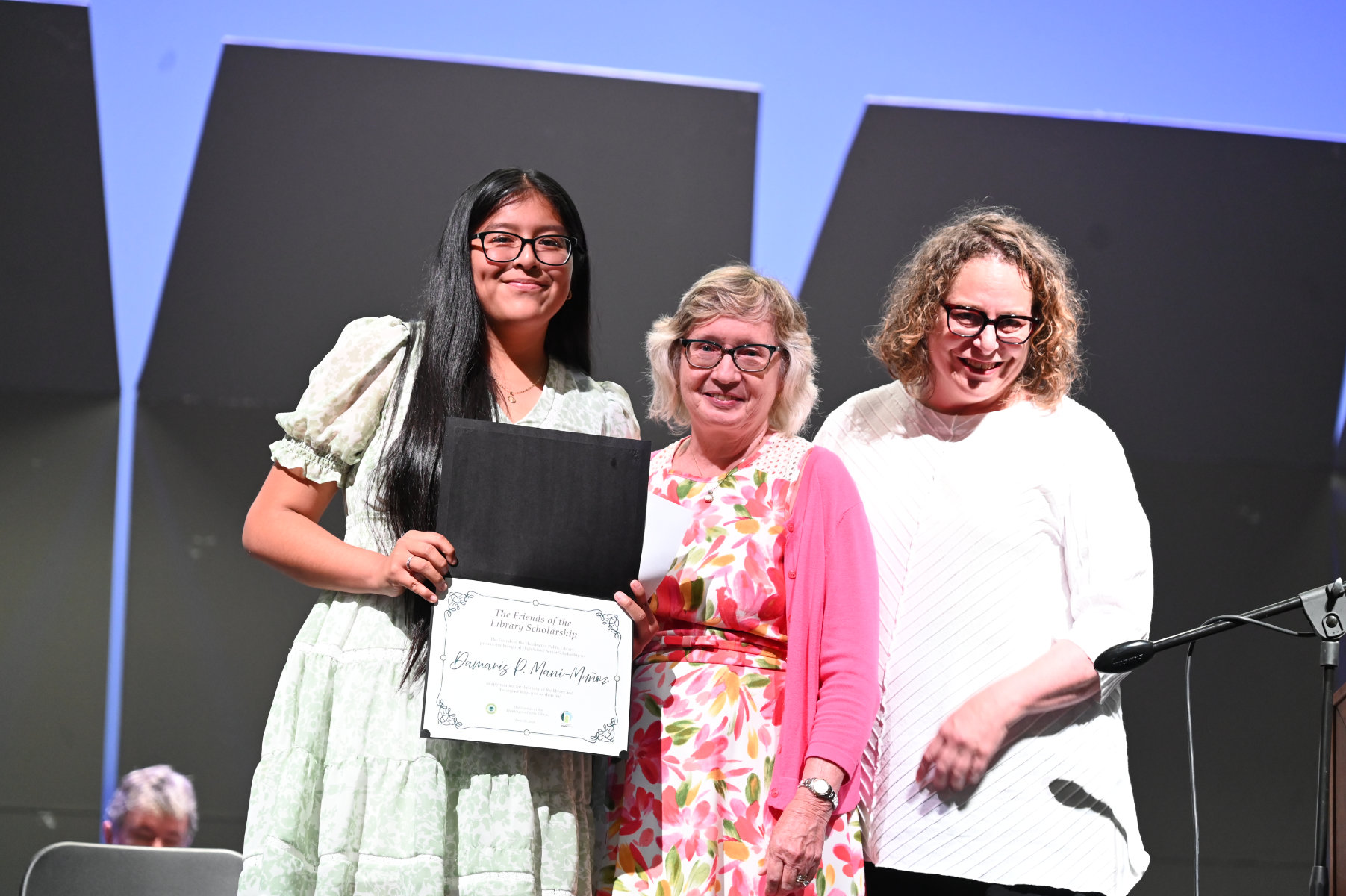  Huntington Public Library officials with scholarship recipient Damaris Mani-Munoz   