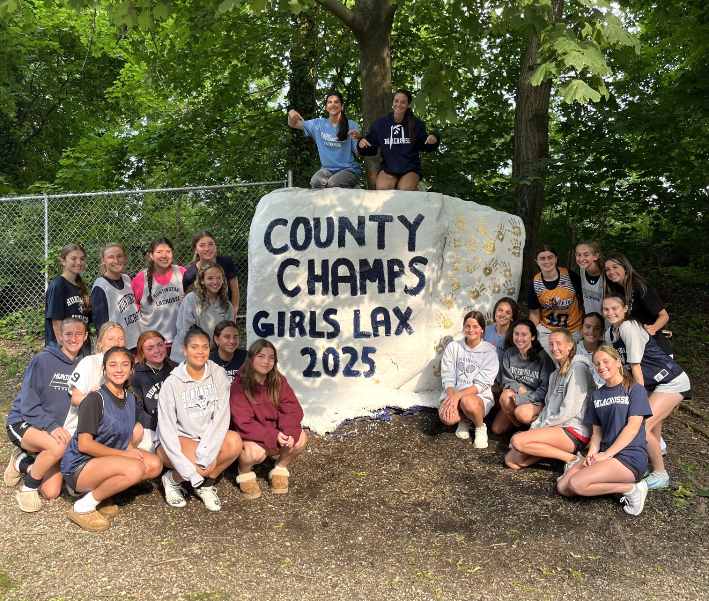  The Blue Devil girls' lacrosse players painted The Rock on Sunday.   