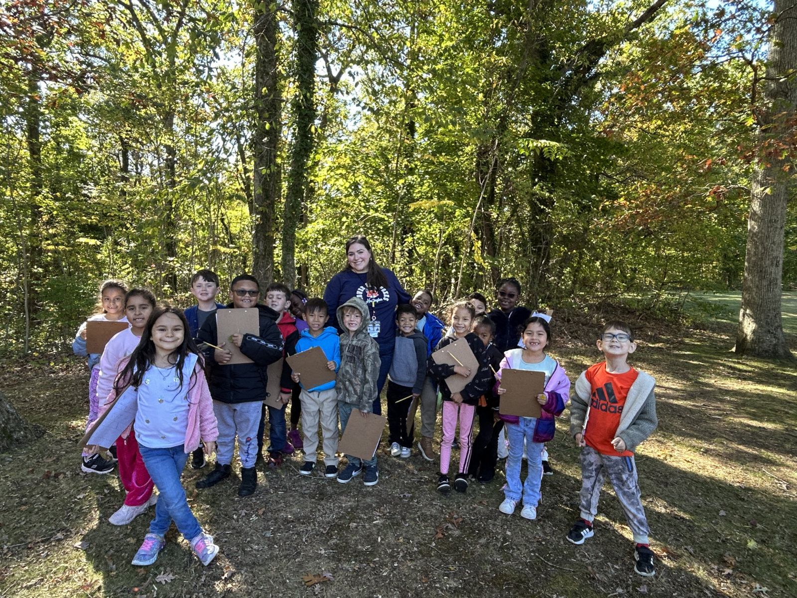  Teacher Caroline Coffey outdoors with her students at Flower Hill.  