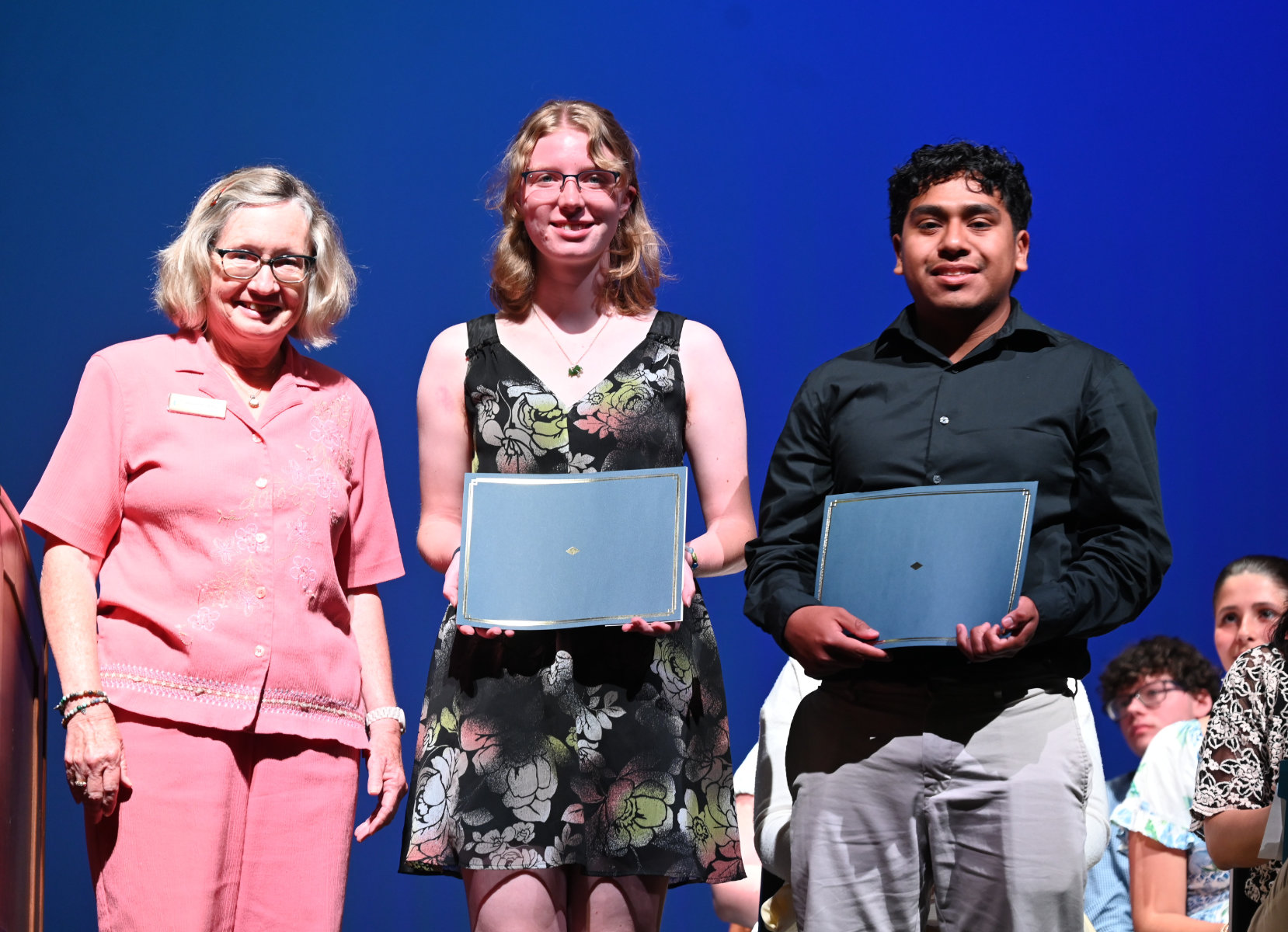  Library Director Joanne Adams presents awards to Amalia Heinz and Edgar Vidal-Villalba   