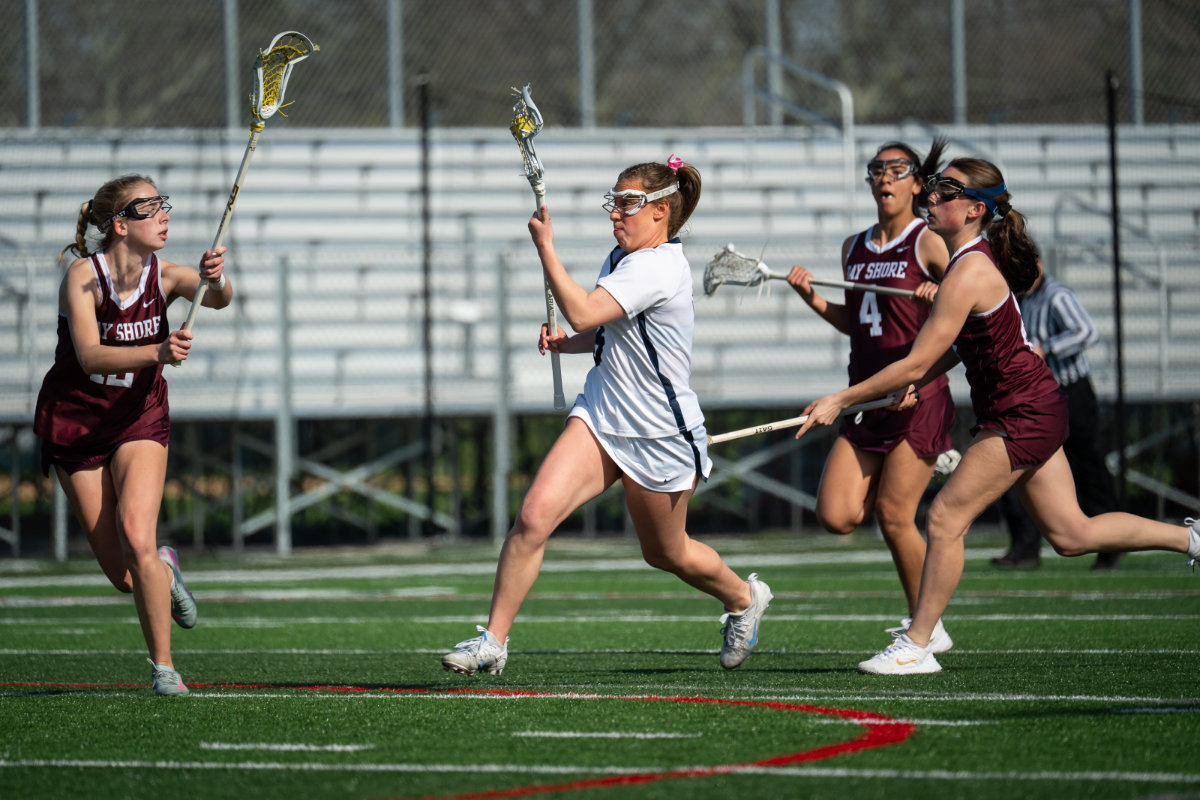  Senior Jolie Weinscreider is chased by three defenders earlier this spring. (Darin Reed photo.)  