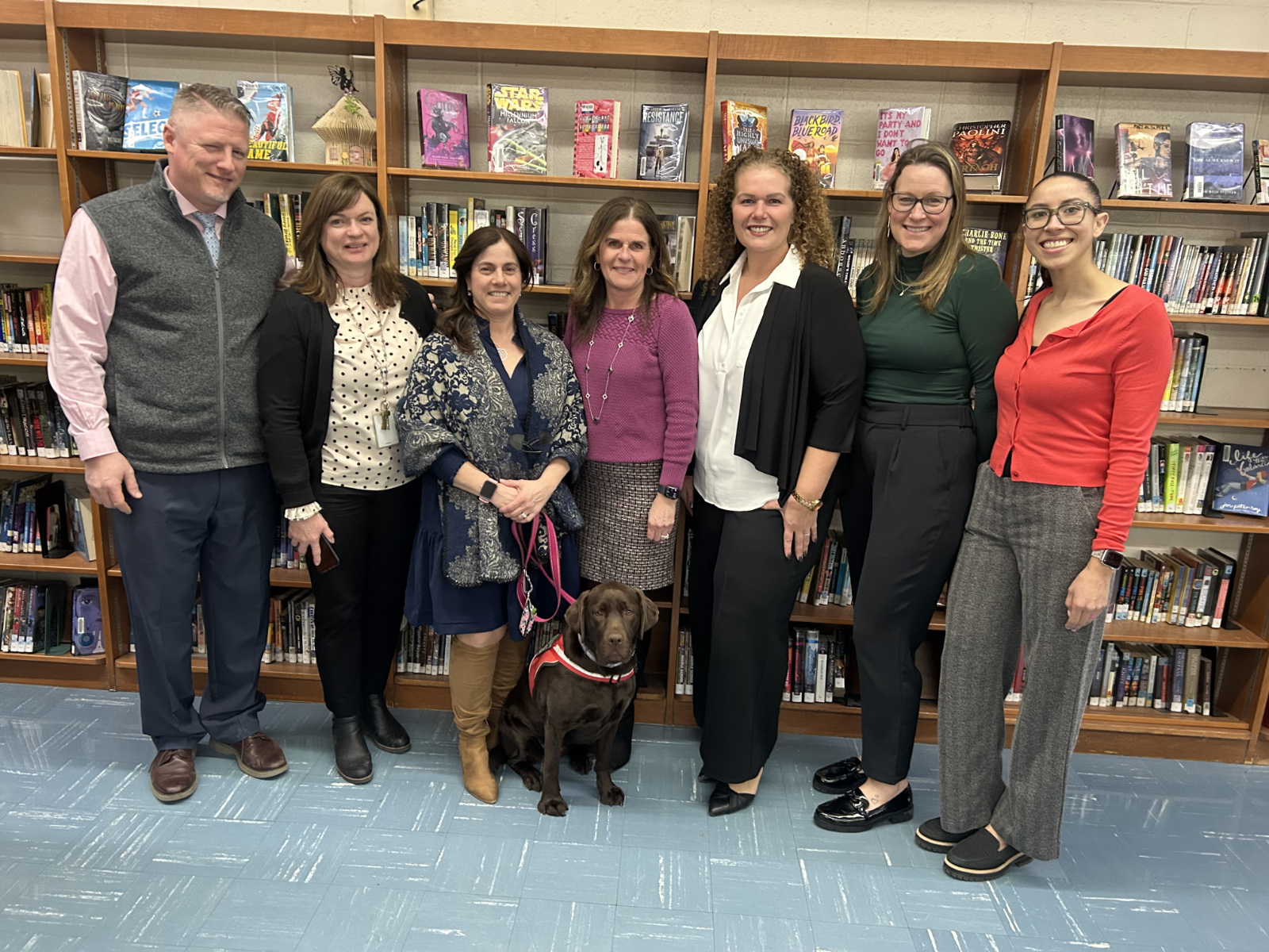  Finley's Carmen DiBartolomeo (with dog) is flanked by school and district officials.  