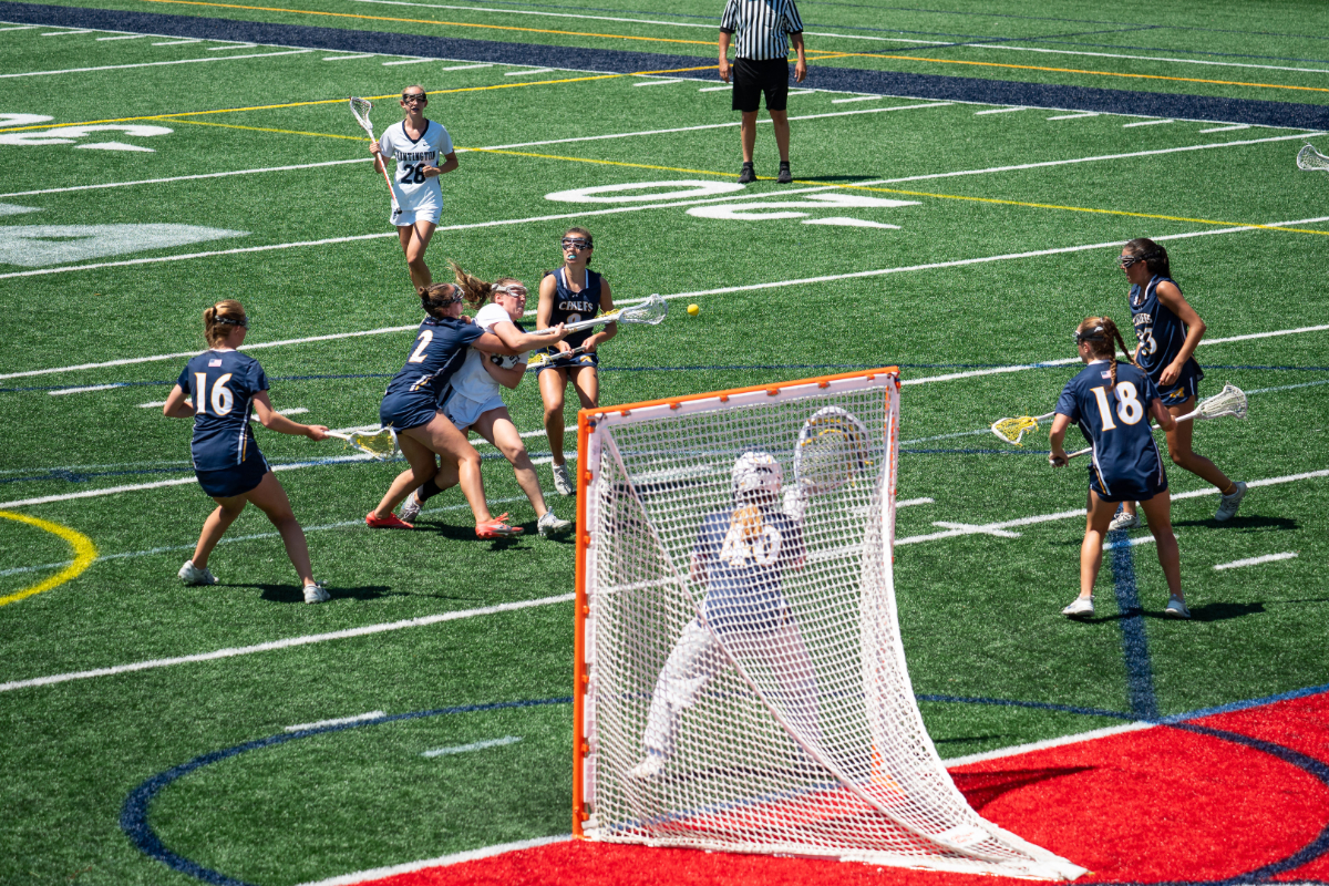 Jolie Weinschreider goes to the goal in the LI Championship game despite tight coverage. (Darin Reed photo.)