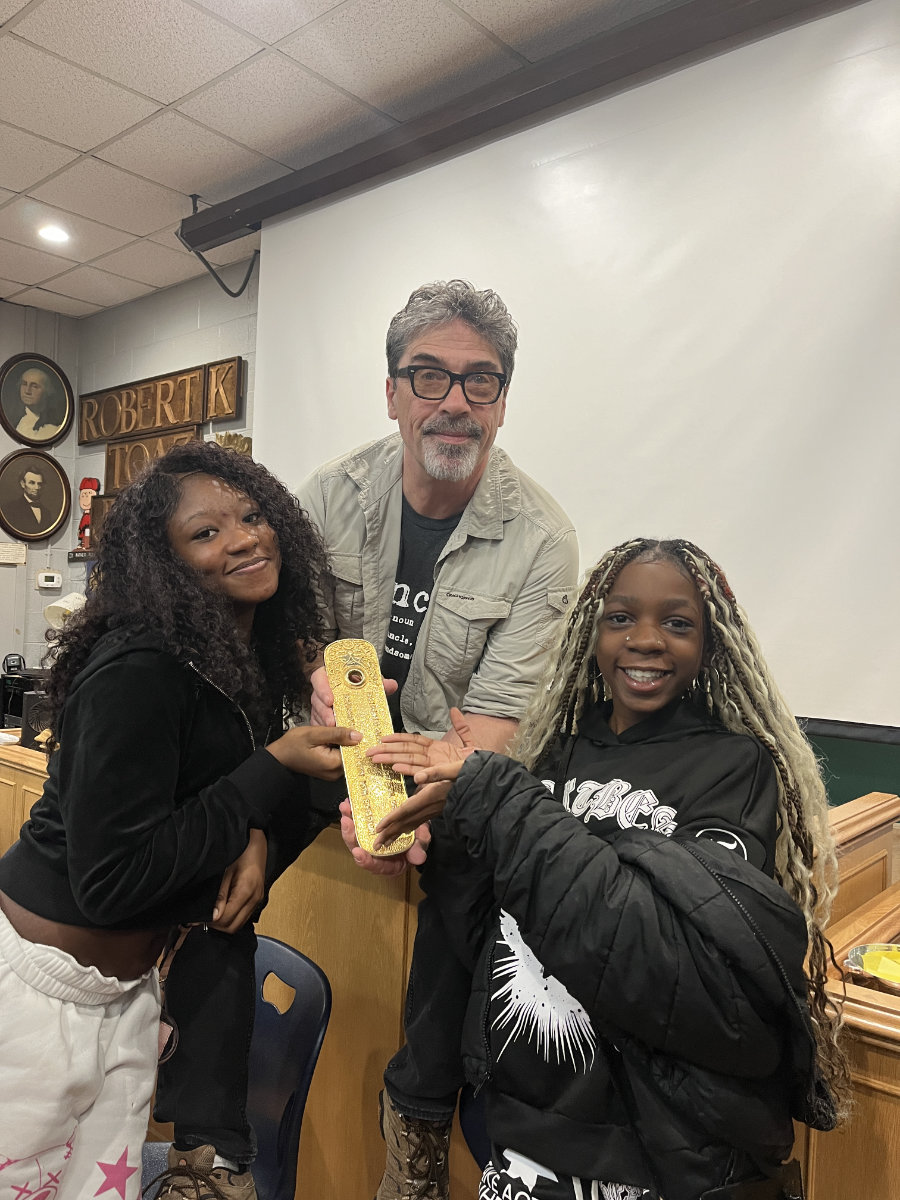  Denis Belliveau shows Huntington students artifacts from his world explorations   