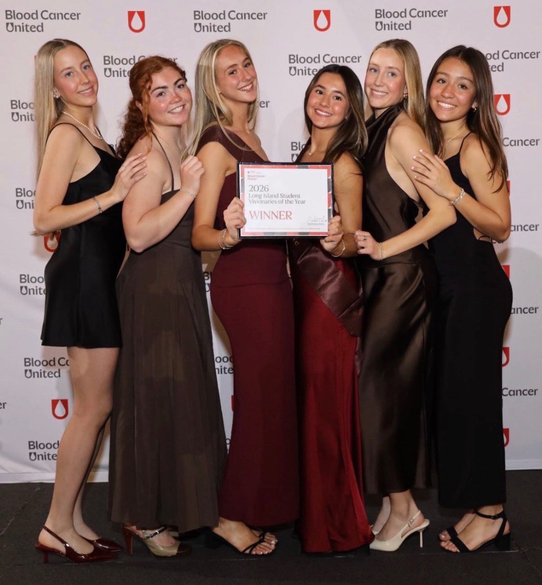 Ava Bencivenga and Violet Palacios (holding certificate with some of their team members and classmates.