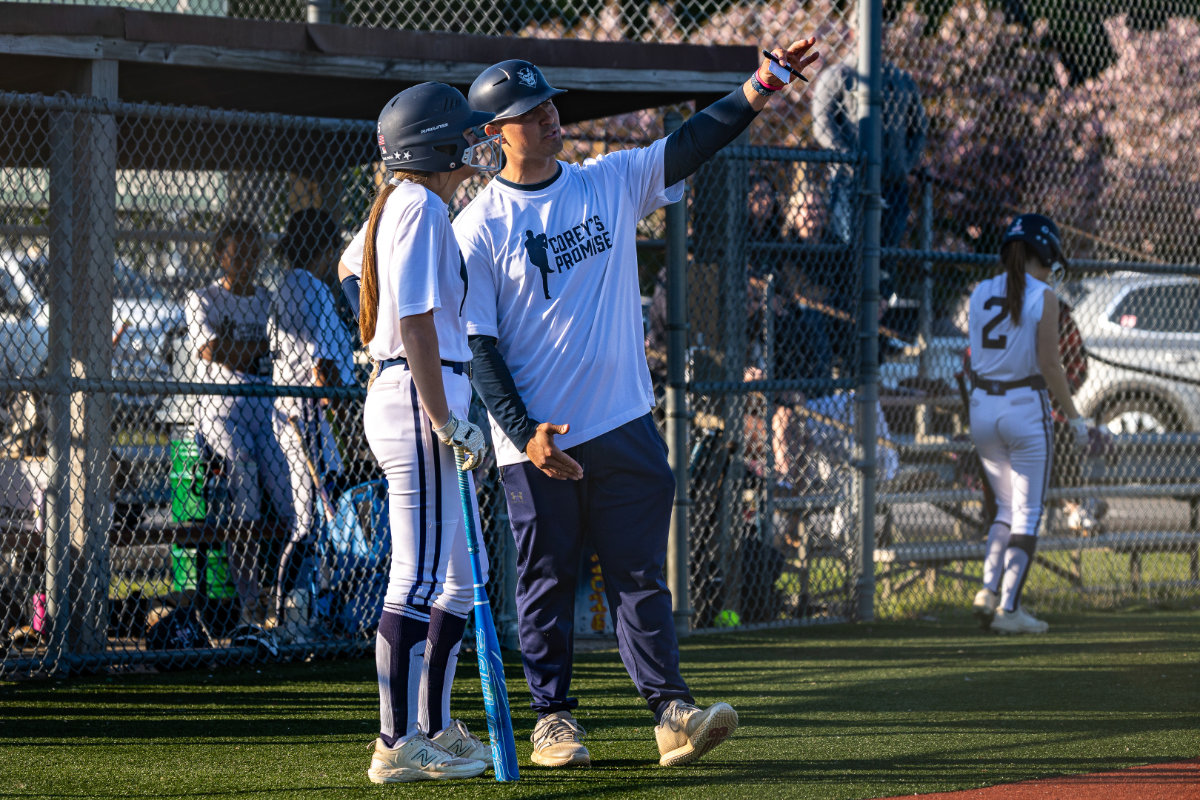 Coach Jake Torres shares a tip with a Blue Devil batter. (Photo by Darin Reed and Carol Merkel.)