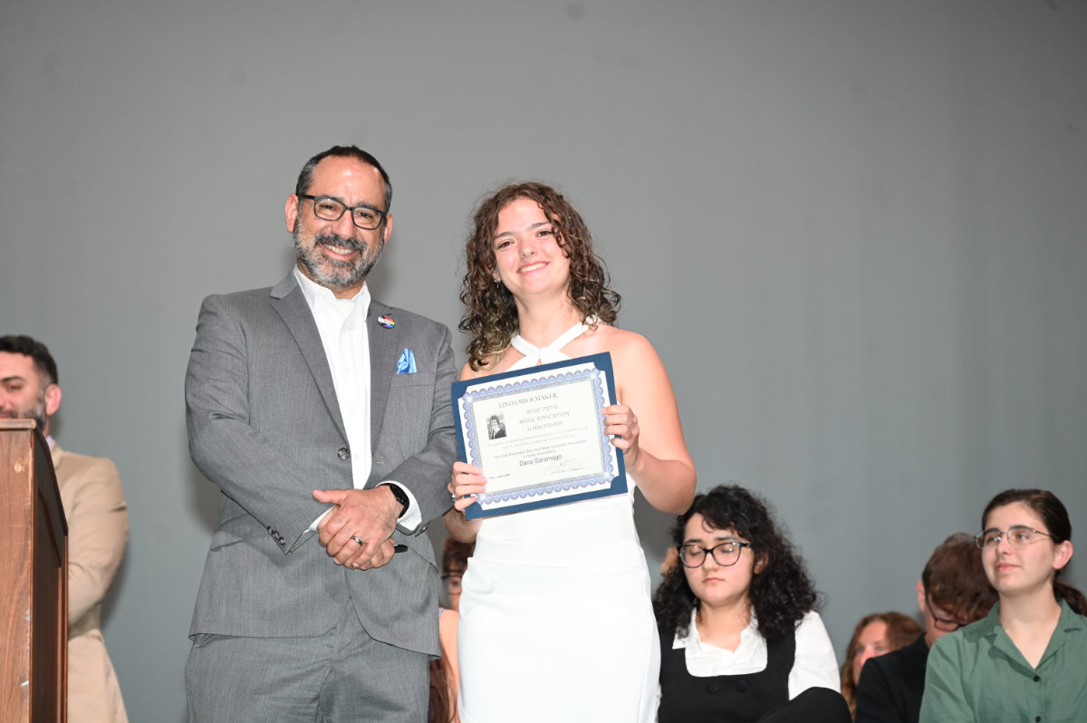  Dr. Jason Giachetti presents the Shoemaker scholarship to Dana Saramago. (Darin Reed photo)  