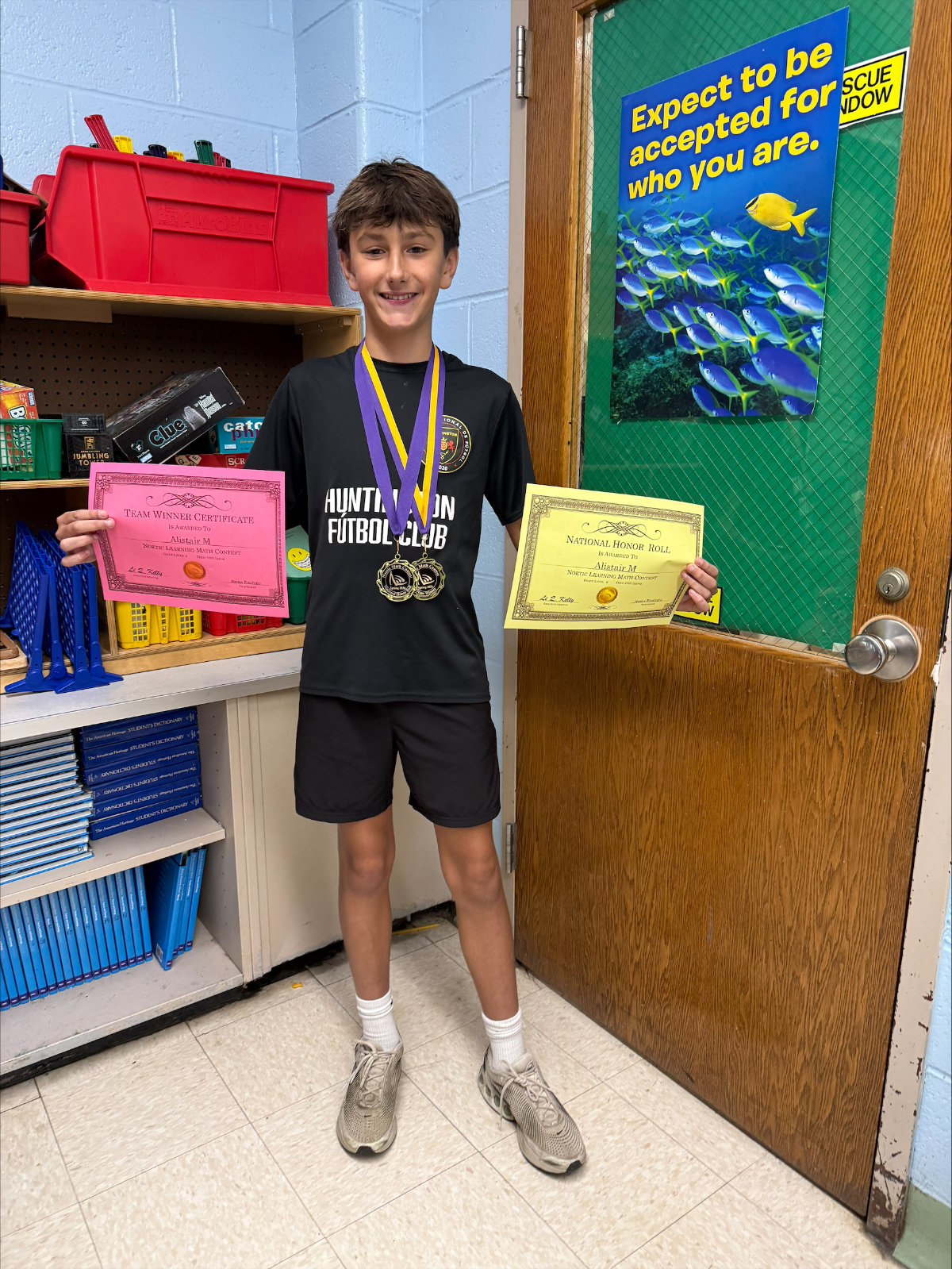  Woodhull sixth grader Alistair KcKay with a pair of certificates. 